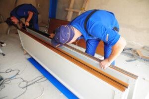 Contractors installing a garage door