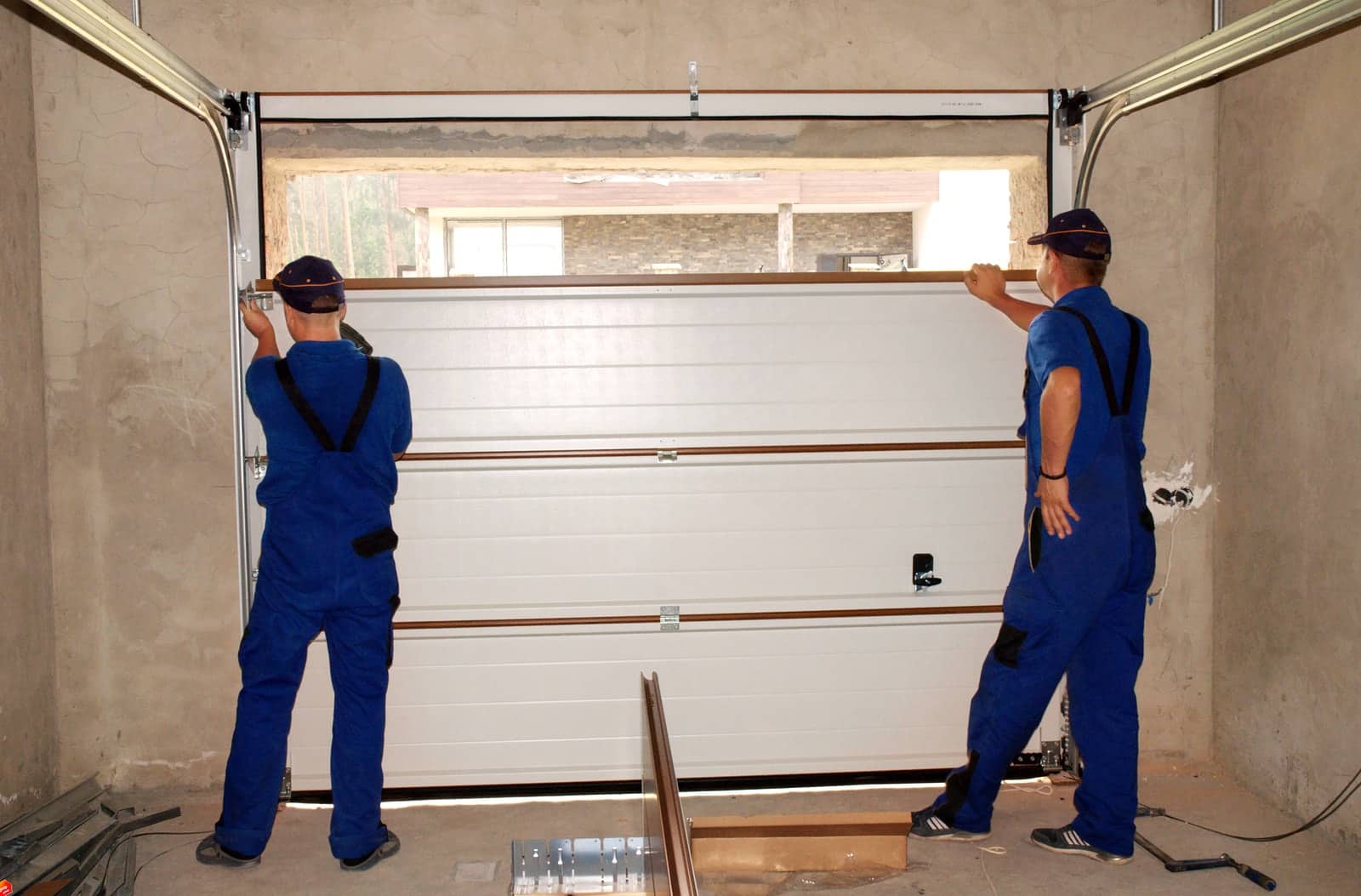 contractors repairing garage door