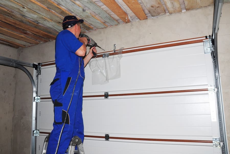 technician repairing garage door