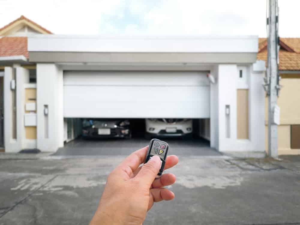 hand holding garage key to open smart door